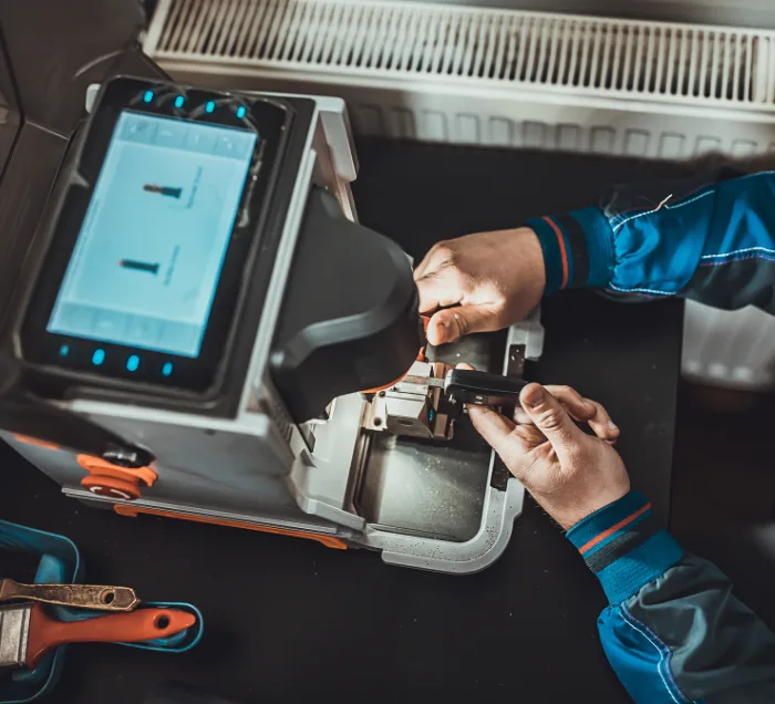 Locksmith technician duplicating a car key in NYC