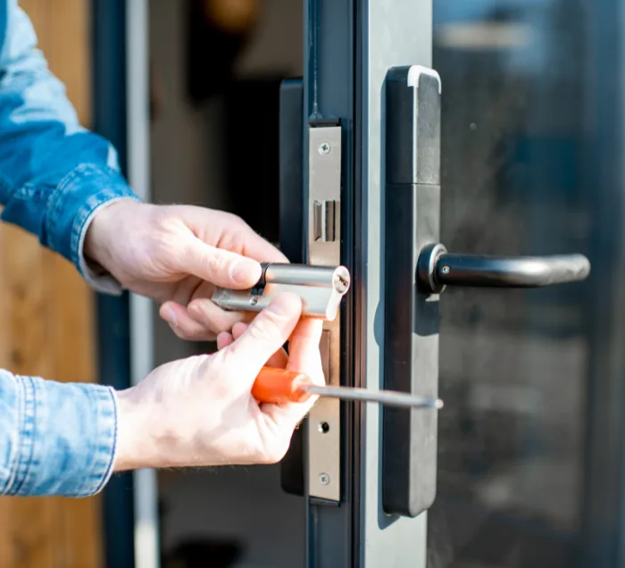 Locksmith technician repairing a door lock in New York City
