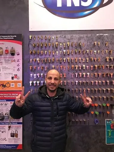 Roye Gvili at the key wall inside the Top Notch Locksmith NYC shop